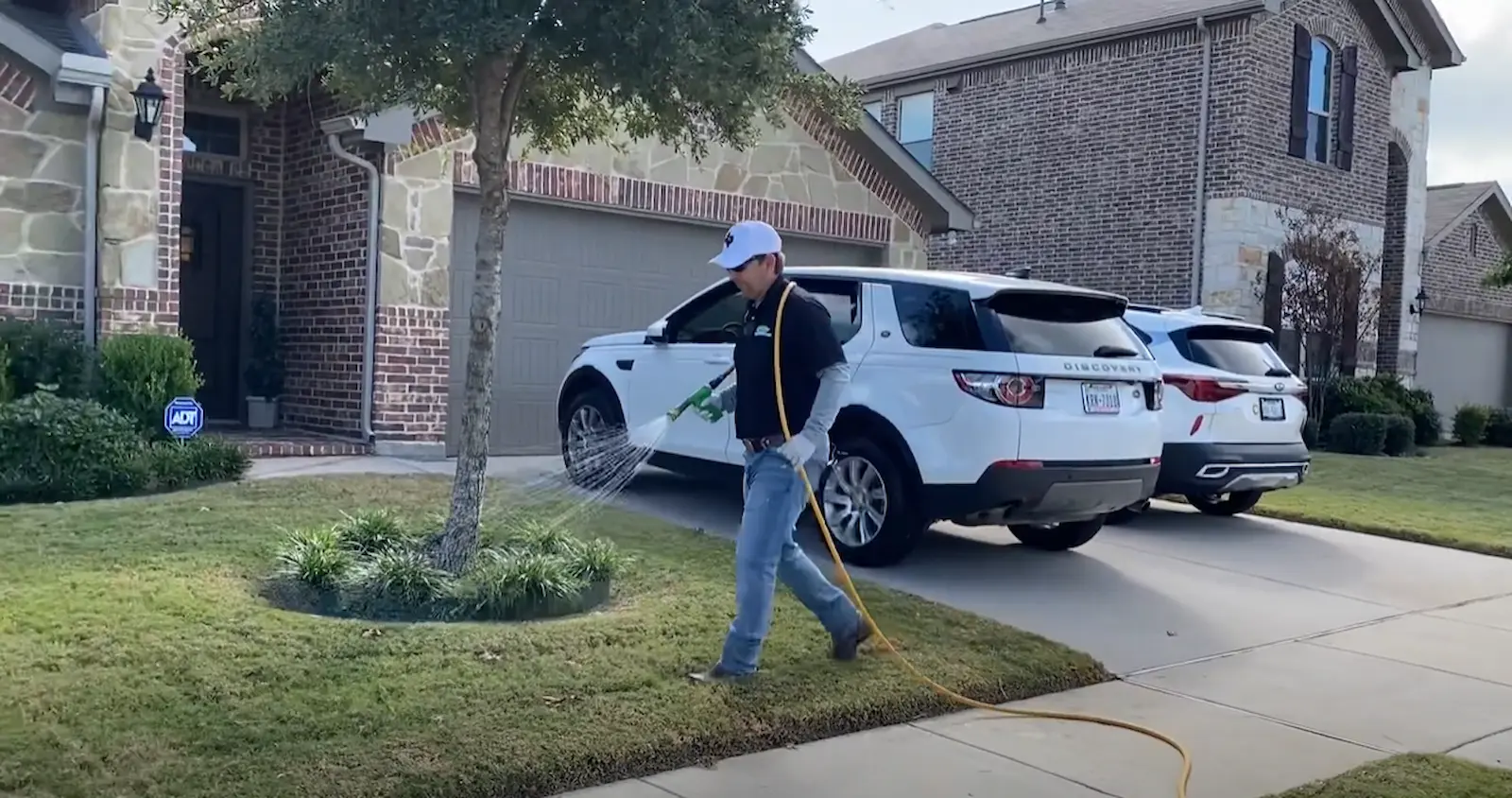 technician spraying front yard