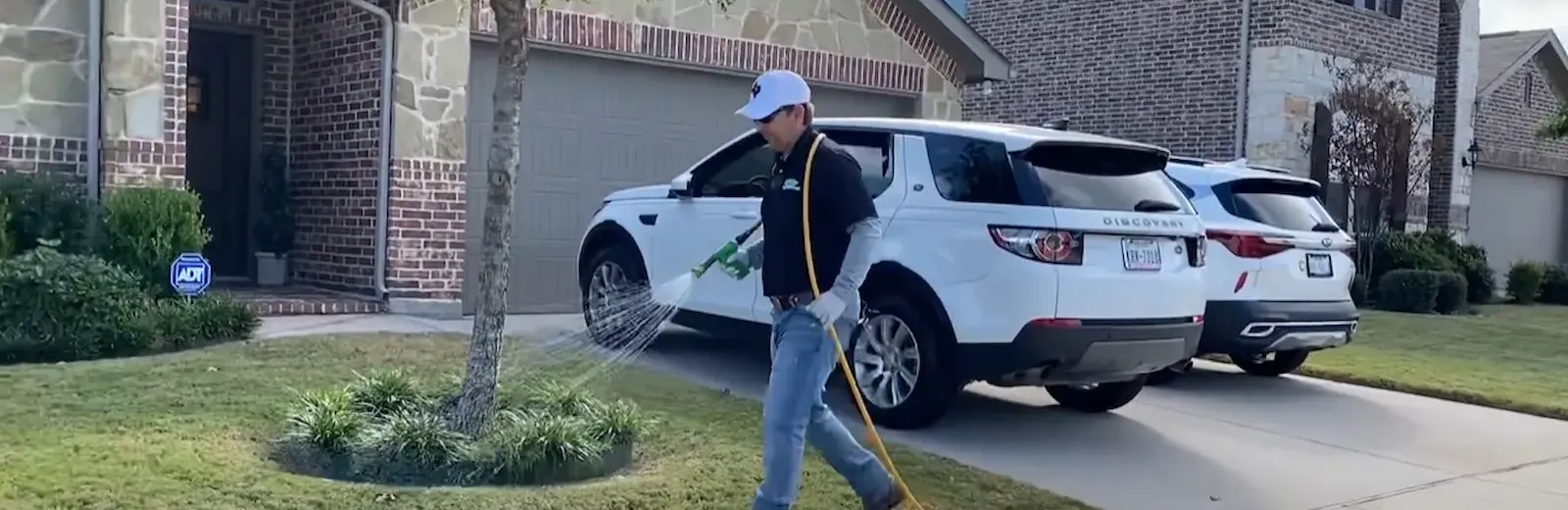 technician spraying front yard